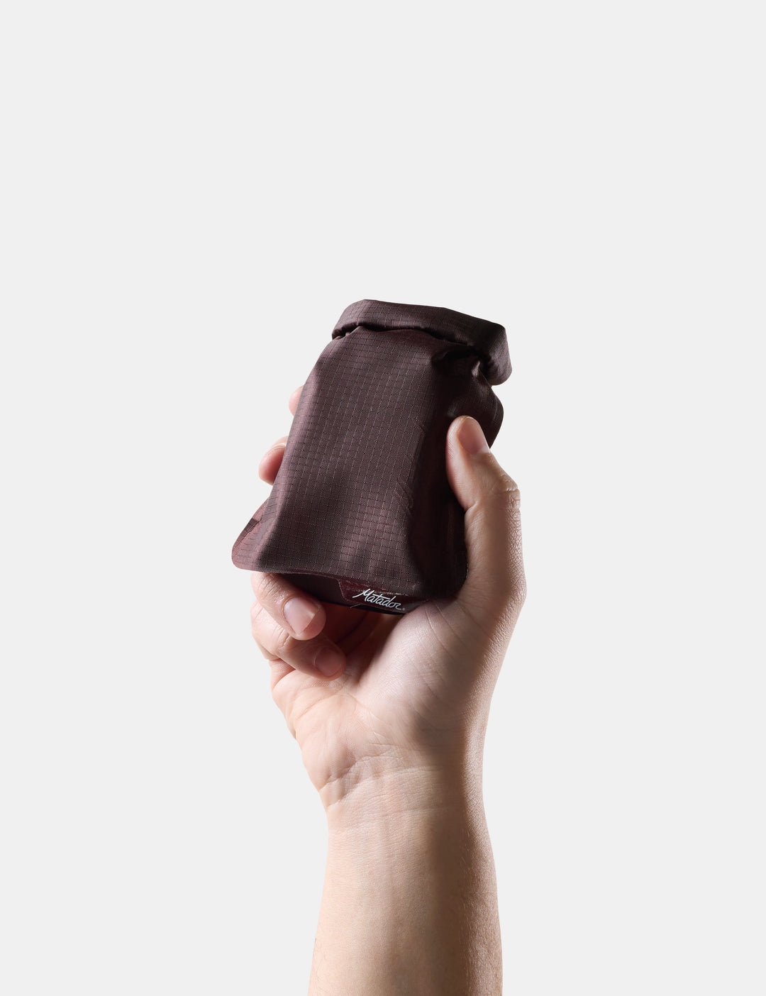 Matador FlatPak Travel Soap Bar Case (V2) in Garnet - hand holding Garnet soap bar case against a white background