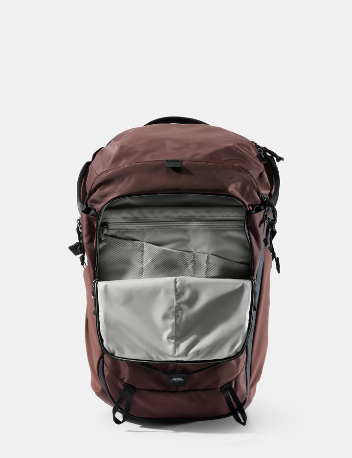 Matador 24L Adventure Pack in Garnet - garnet backpack with open front pocket on a light gray background