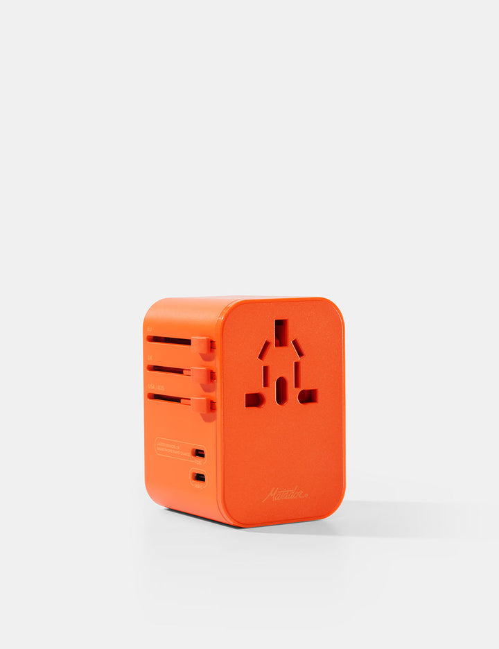 Matador Global Travel Adapter in Orange - orange travel adapter on a white background