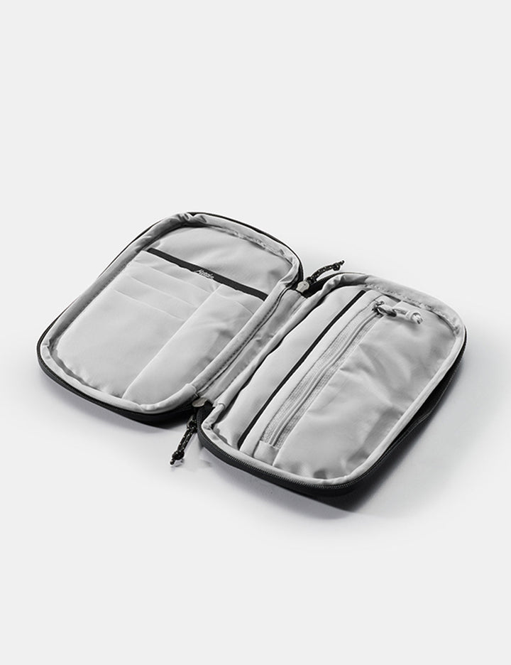 Matador Global Travel Stash in Black - open travel wallet on white background with empty pockets and zipper